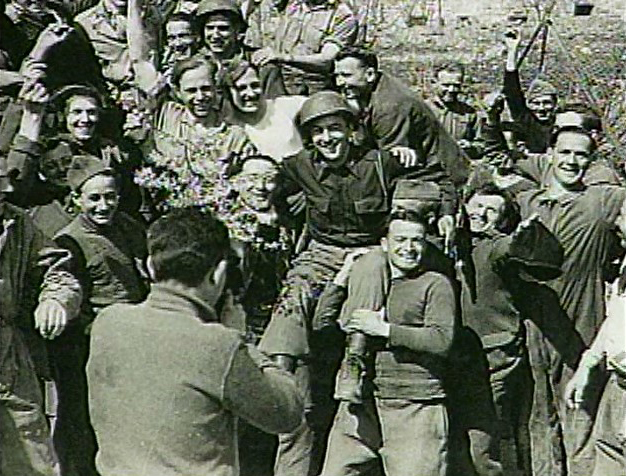 Judge Jasen on the shoulders of liberated prisoners of war near Augsburg, Germany.
